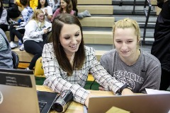 Percival instructing a student worker during the 2018-19 basketball season.